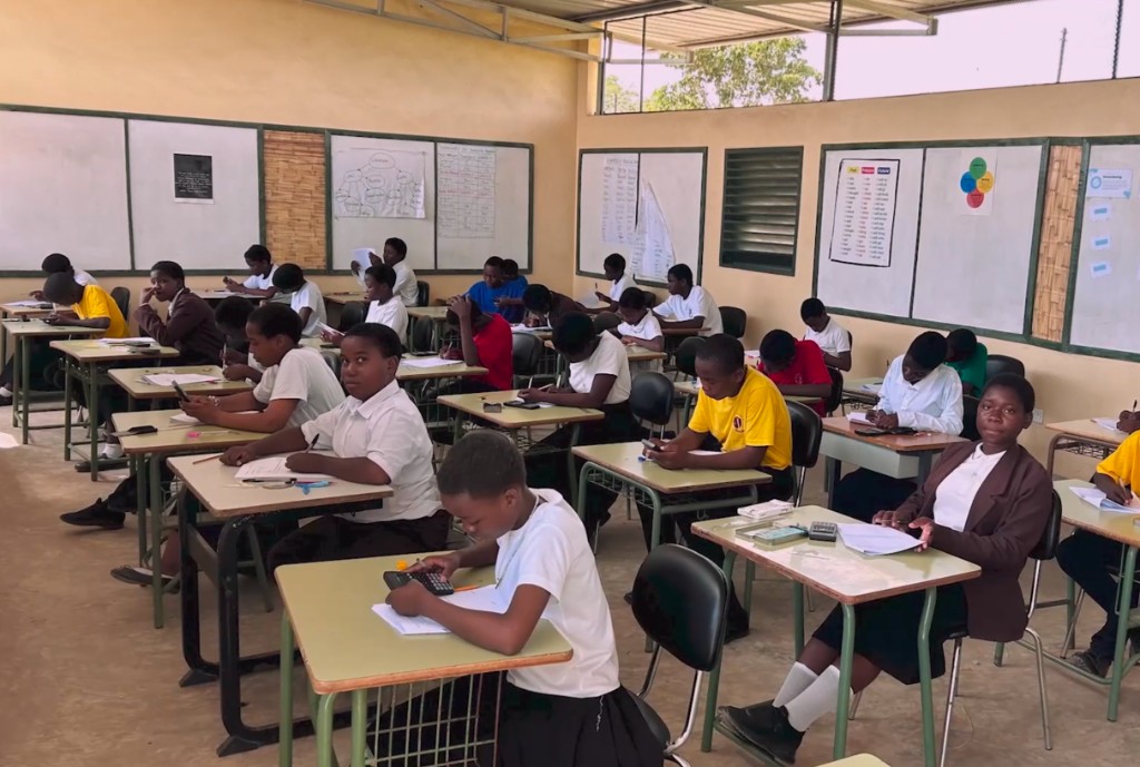 Students working during a classroom examination at St Joseph Integrated Secondary School